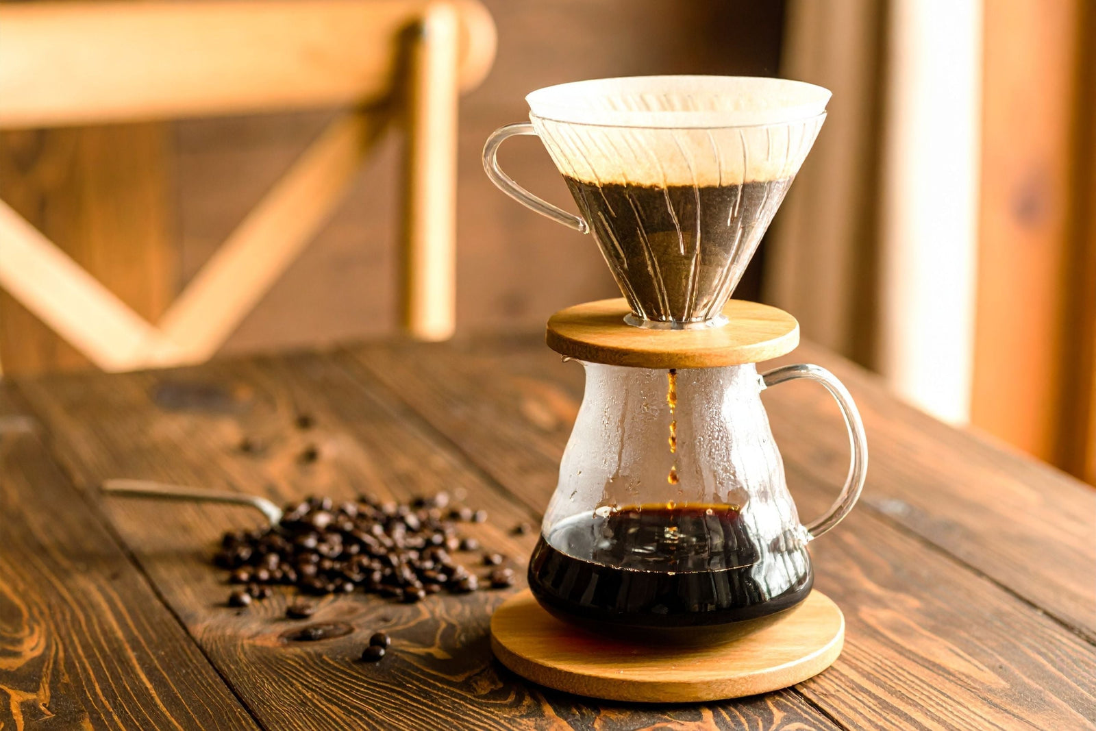 Classic Hario V60 Pour-over sitting on top of a Hario Pitcher. Coffee is dripping through the filter into the vessel. 
