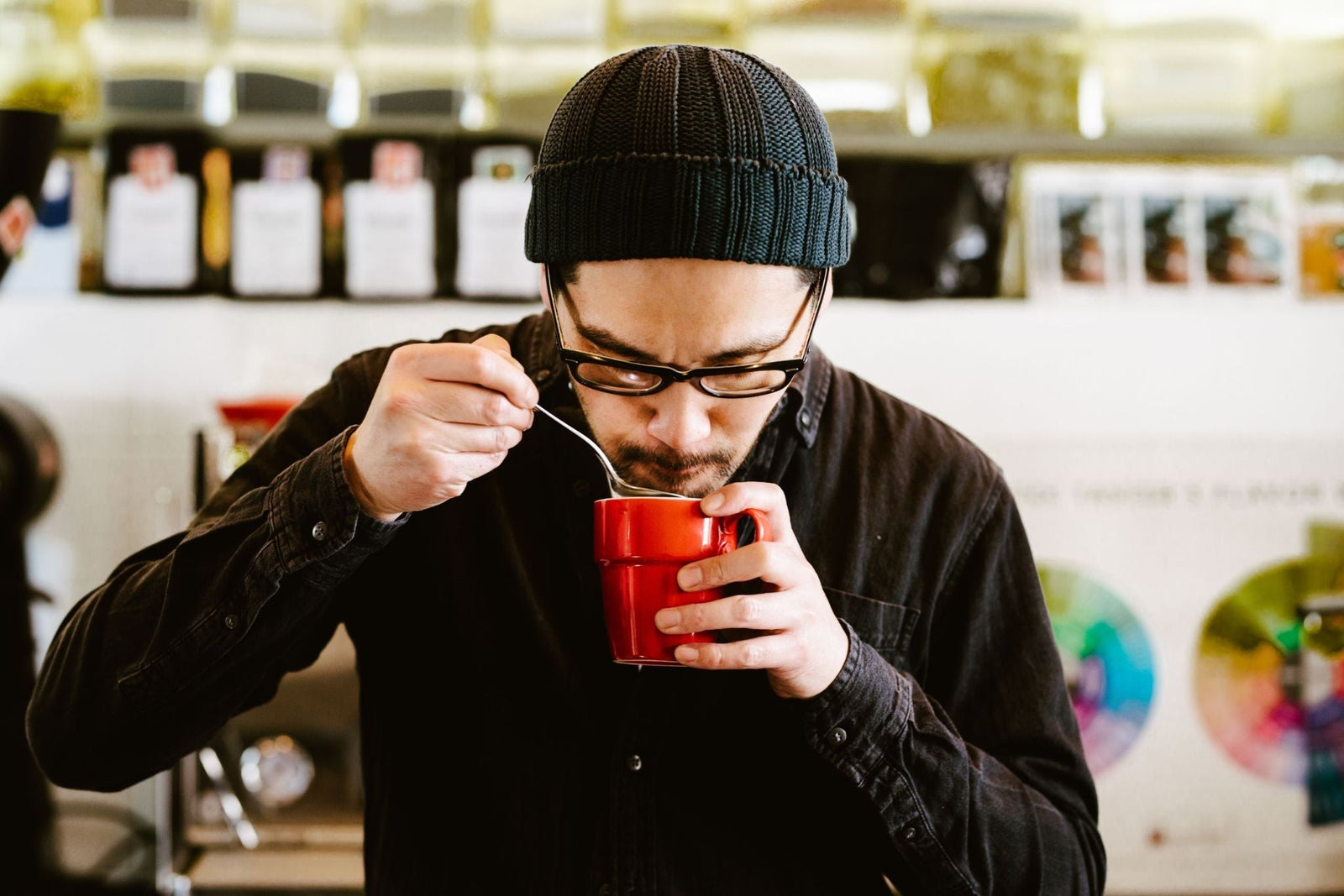 A cup of coffee being brewed and tasted to diagnose sour flavor