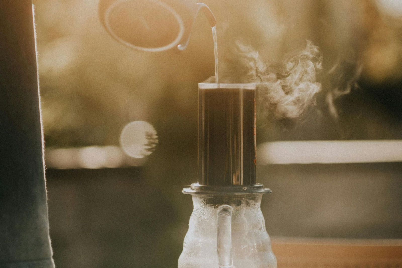 An Aeropress sitting on a glass carafe