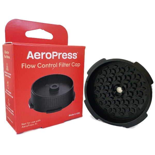 Red AeroPress Flow Control Filter Cap box on a white background with the cap next to the box