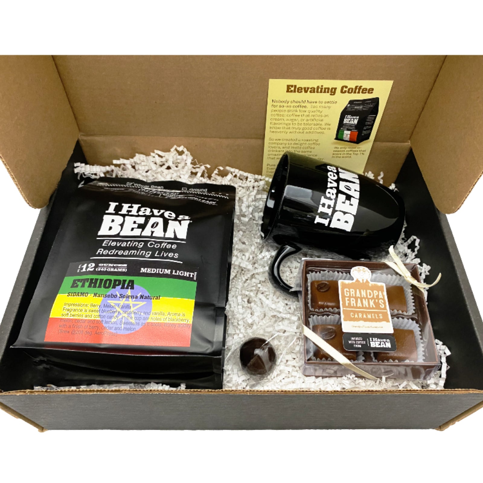 Inside of the Baristas Gift Box with coffee samples, black coffee mug and caramels