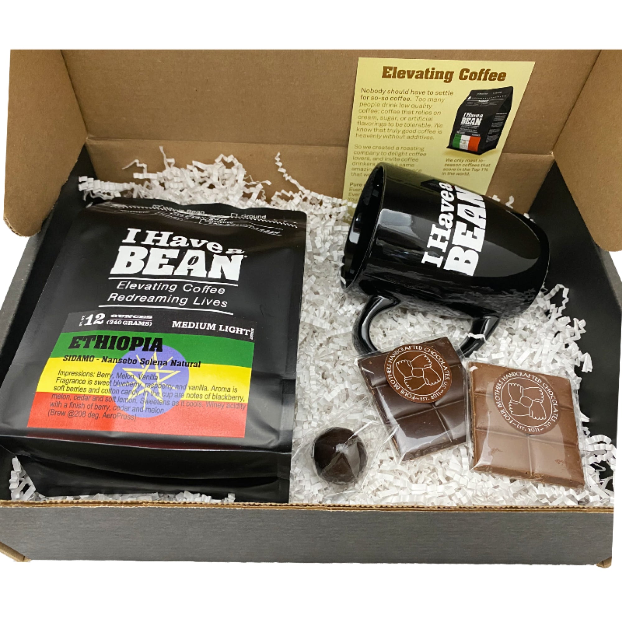 Inside of the Baristas Gift Box with coffee samples, black coffee mug and chocolate