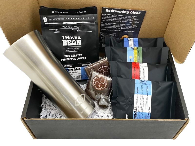 Inside of the Roast Masters Gift Box with coffee samples, silver travel mug and chocolate